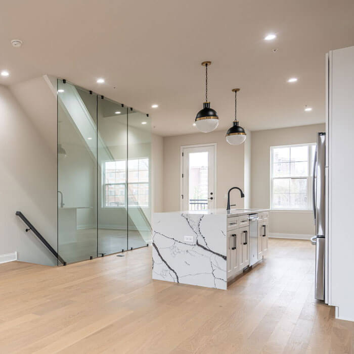 kitchen with manufactured quartz counters w/ island and glass partition